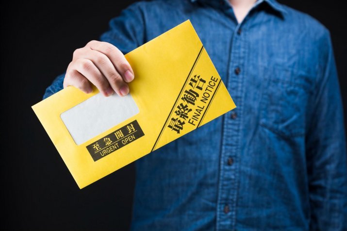 A man holding a demand letter