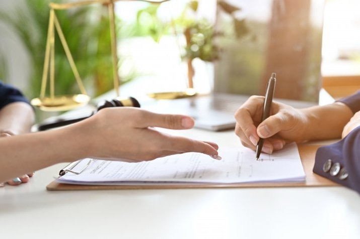 A representative and a customer explaining the rental contract